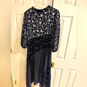 Women’s beautiful 3/4 sleeve floral midi dress with intricate design.